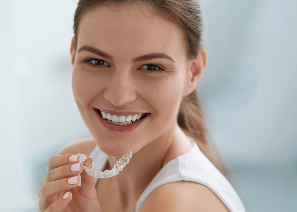 Girl Holding an Invisalign Tray