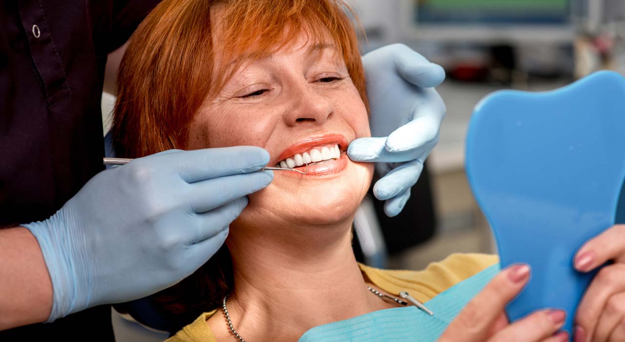 Woman Showing her Full Mouth Denture Implants