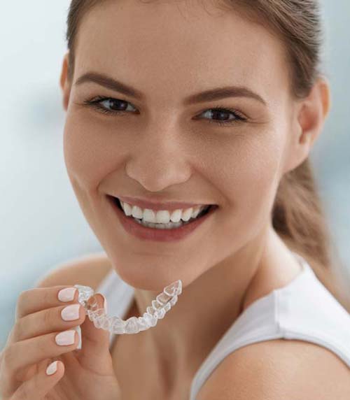 Young Woman Holding an Invisalign Tray