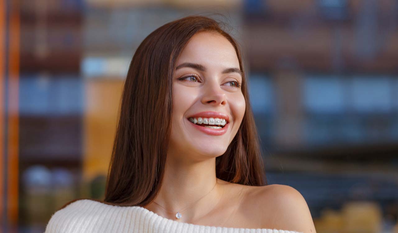 Young Woman Smiling with Braces on Teeth